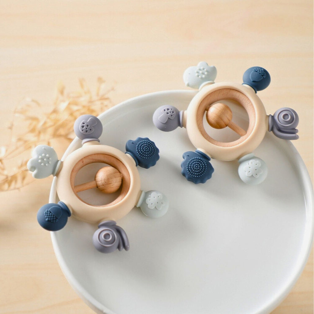 Baby silicone teether color blue with wooden ring and rattle