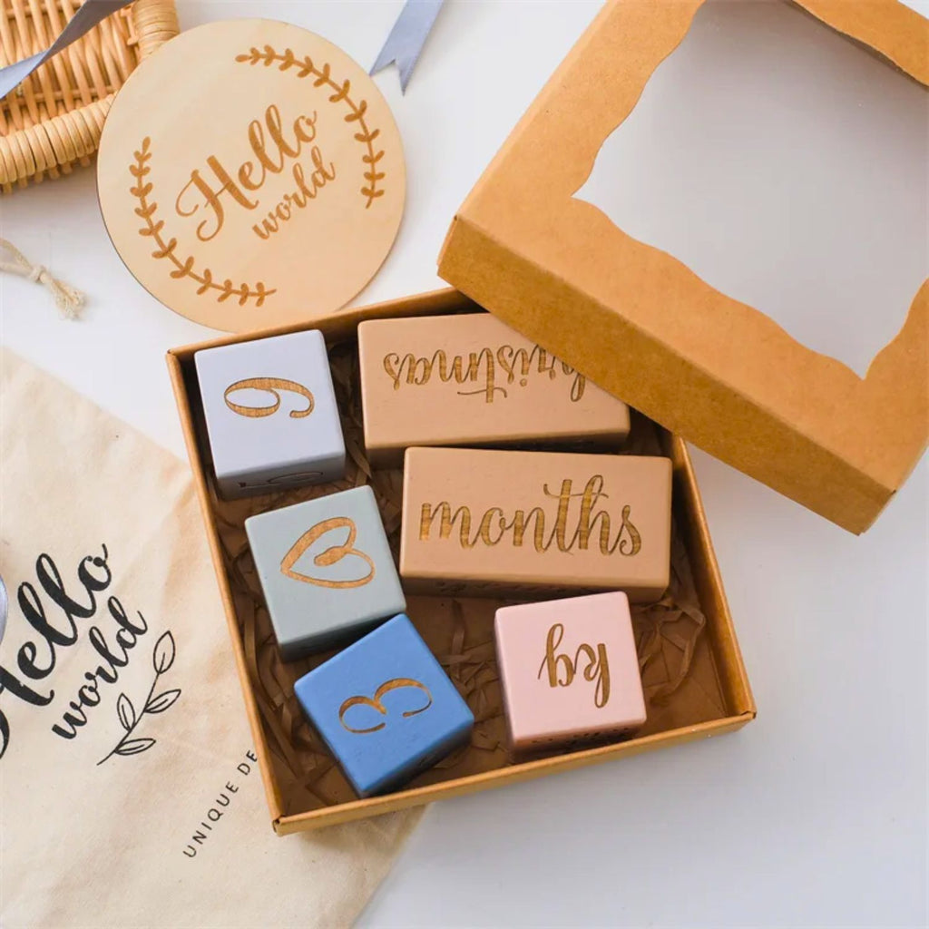 Wooden baby milestone blocks blue and natural wood color in an opened gift box