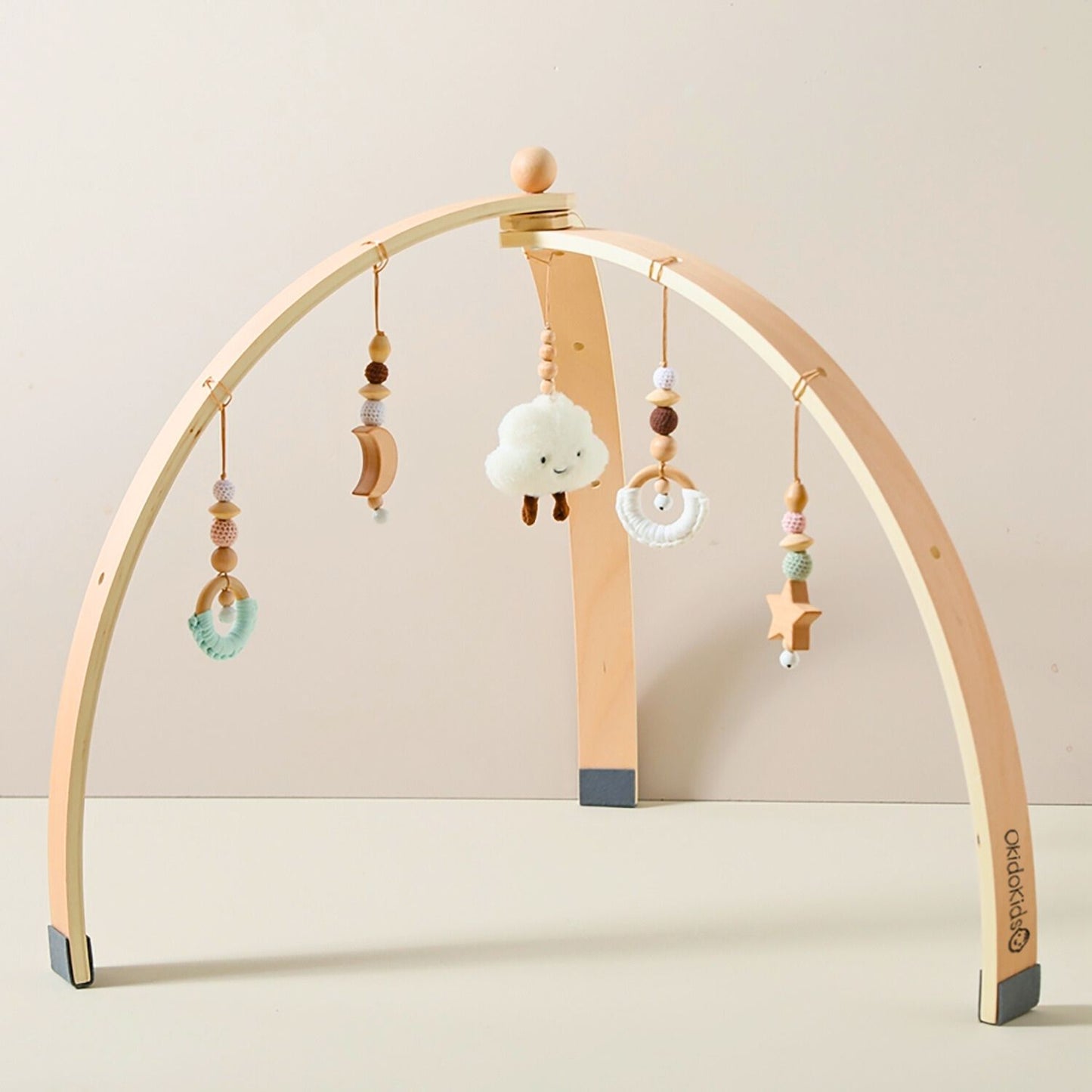 Wooden baby play gym with hanging toys rattles.