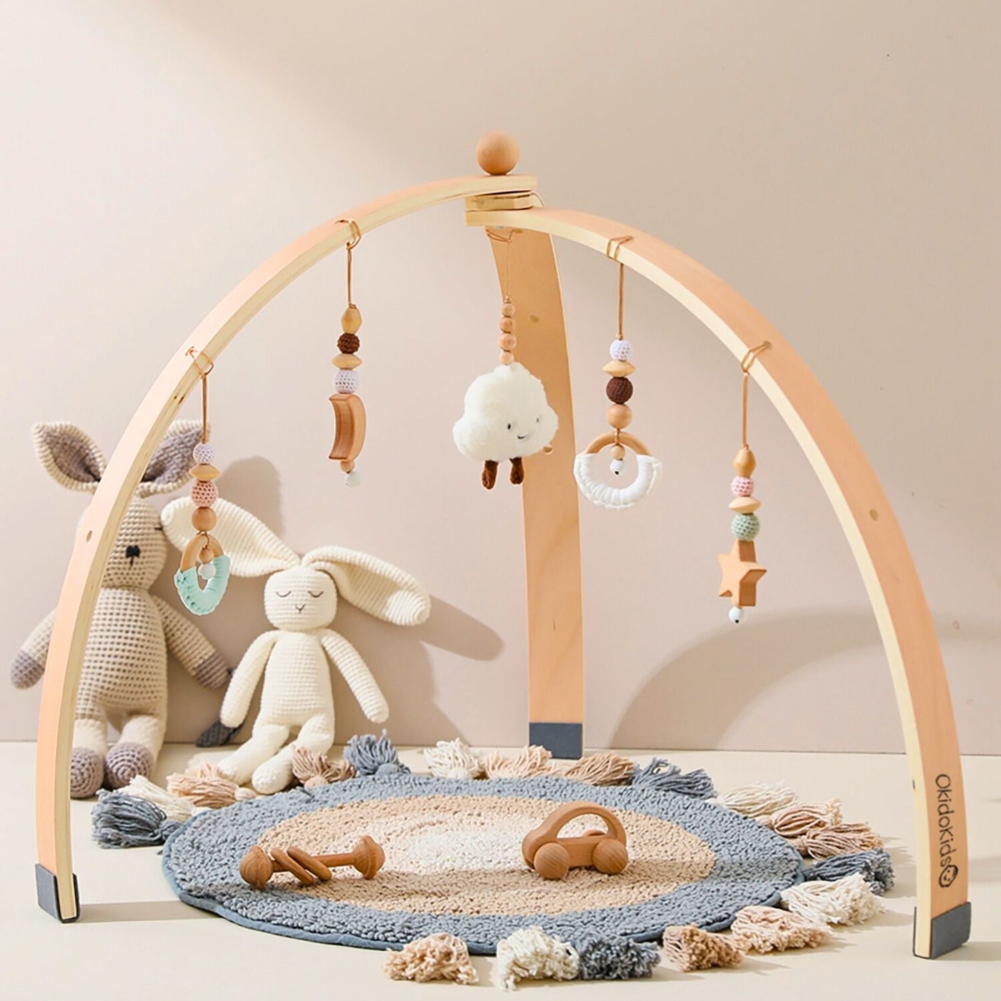 Wooden baby play gym with hanging toys rattles.